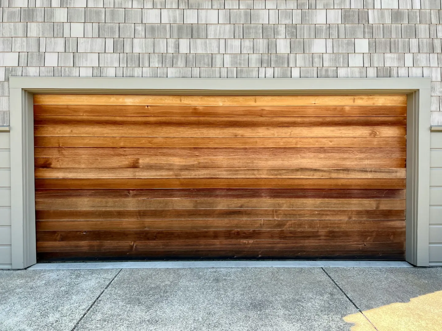 Wood-look sectional garage door used as contextual installation imagery