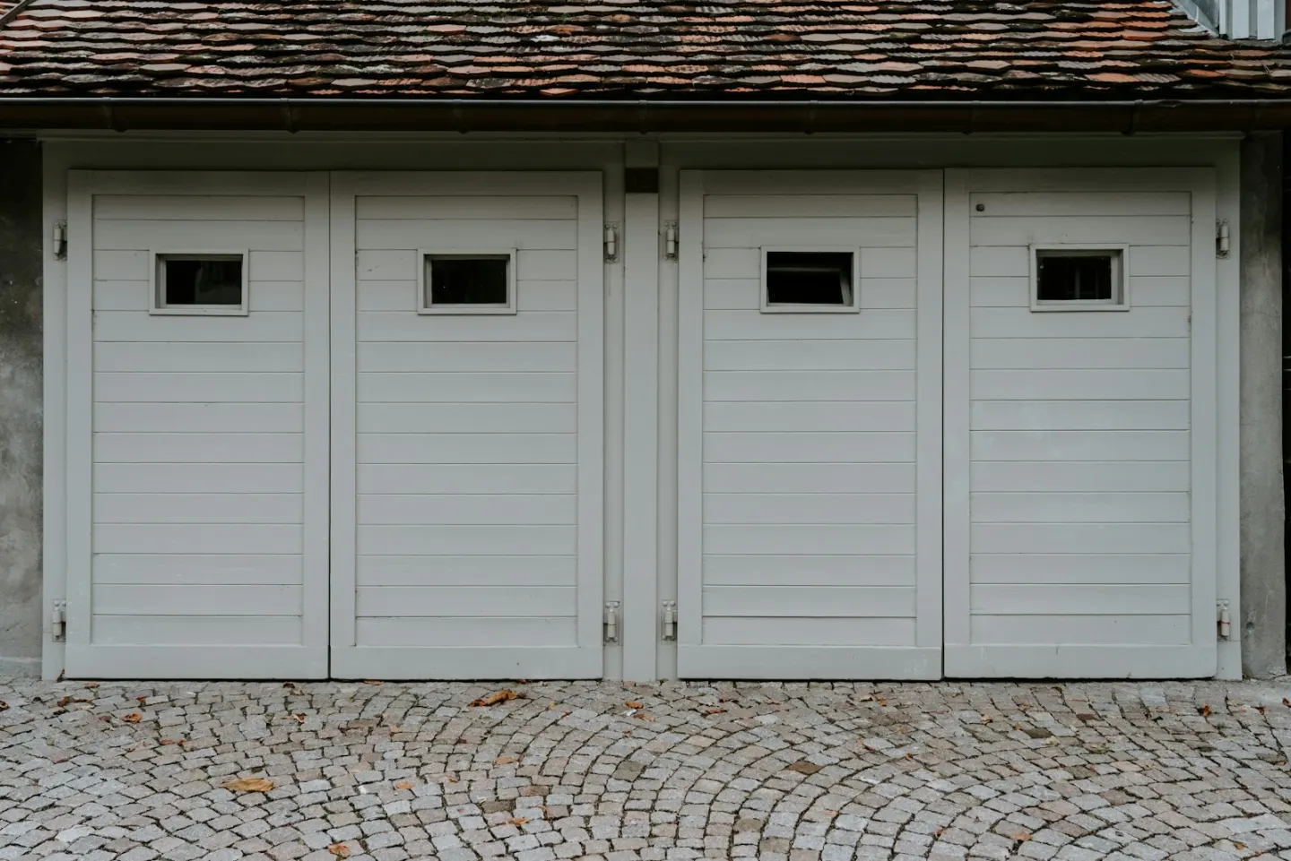 Residential garage exterior used as contextual opener-repair imagery