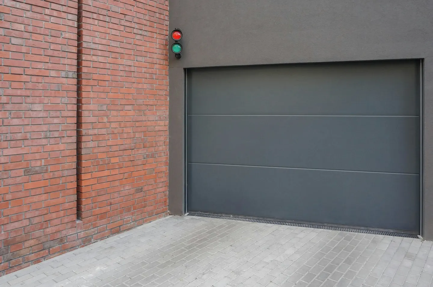 Grey sectional garage door used as contextual track-repair imagery